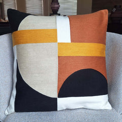 Abstra Embroidered Cushion 45x45cm with vibrant colors and geometric patterns on a sofa.