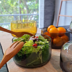 A hand-blown, solid-colored Ajana Bowl Grey featuring clear lines around the edge and a thick glass base, by ASA selection