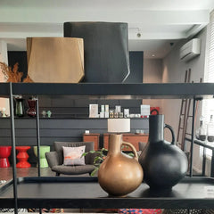 A family of Aluminium Vases in blackish bronze and antique brass finish