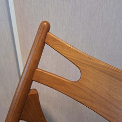 Close-up of a teak Anker Dining Chair Black Leather backrest