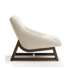 An armless chair with a solid wood base in a dark finish and beige fabric upholstery.