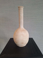 A beige ceramic Atlas Vase with a natural texture, long neck and a round body