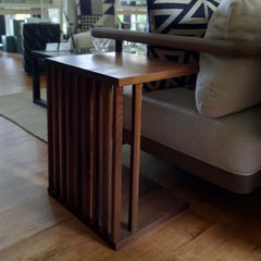 A rectangular side table made of solid walnut wood with a natural finish, featuring a slim profile and a flat, rectangular top.