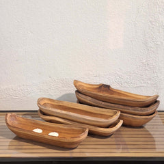 Handcrafted Bread Bowl Small Teak in a natural boat form with flowing grain and organic detailing. Each piece is unique, bringing warmth and character to any table setting or interior.
