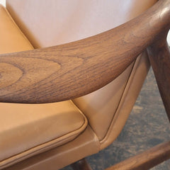 Close-up of Cynthia Armchair Tan Leather with teak armrest and tan colour leather cushion