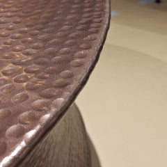 A unique Drum Coffee Table with hammered patterns, finished in oil brass matt