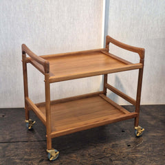 Teak bar cart with two shelves on wheels and handles on both sides