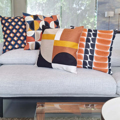 Embroidered Cushion showcased on a modern sofa, featuring vibrant geometric patterns and colors for stylish interiors.