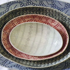 Stack of Etosha Dishes with decorative patterns, by Wonki Ware