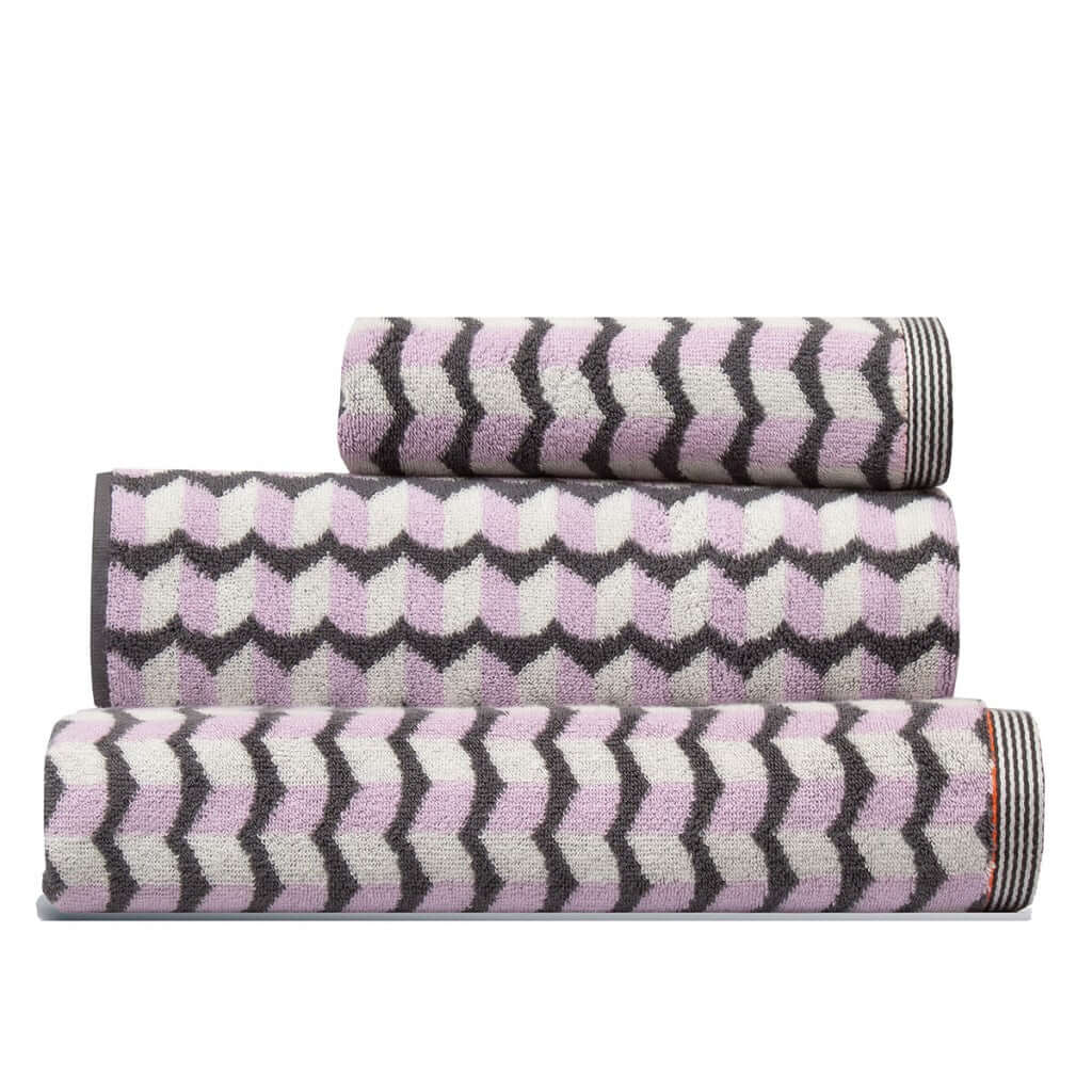 Set of three pink grey white patterned towels stacked, a hand towel, a bath towel and a Finchley Bath Sheet, by Margo Selby