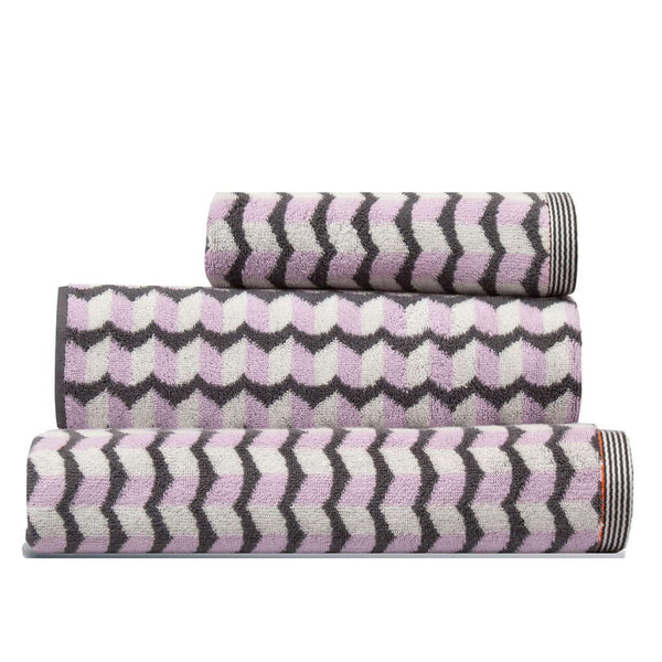 Set of three pink grey white patterned towels stacked, a Finchley Hand Towel, a bath towel and a bath sheet, by Margo Selby