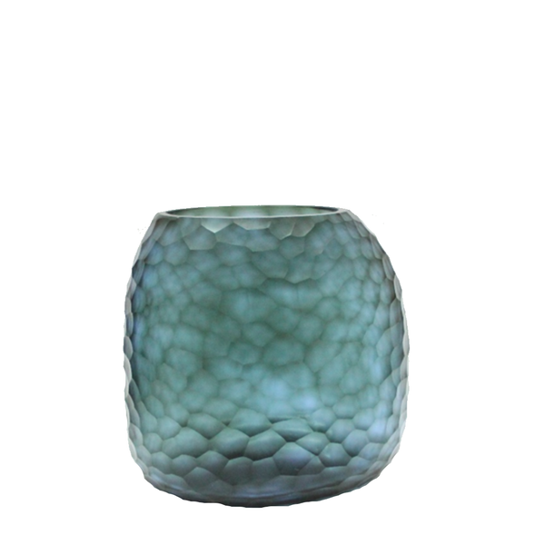 Fjord Vase 24cm in deep teal-blue frosted glass, its entire surface covered in dense small hammered cells that scatter light like sunlight breaking across cold, mineral-rich water.