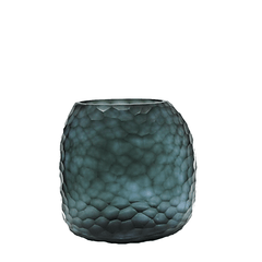 Fjord Vase 24cm in deep teal-blue frosted glass, its entire surface covered in dense small hammered cells that scatter light like sunlight breaking across cold, mineral-rich water.