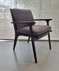 A black ash wood frame dining armchair with upholstered dark grey fabric seat and backrest.