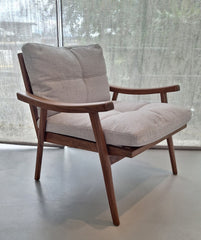 A walnut frame armchair with loose back and seat cushions