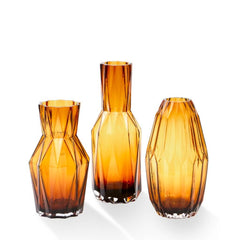 A family of Glass Folds Vase Ochre with a unique design by Pols Potten