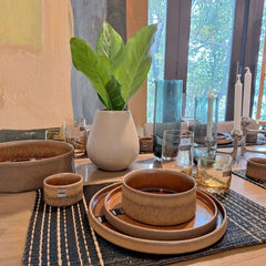 A round, brown stoneware Form Art dinnerware with a matte finish and a visible brown glaze, by ASA selection