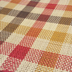 Close-up of a Iraca Rectangle Placemat Yellow Red Brown handmade in colombia