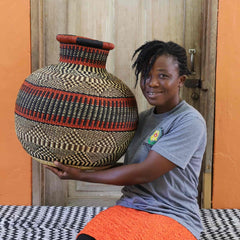 Woman holding a large Baba Tree Jemima 10 Cows Decor Basket 00028 with a patterned 