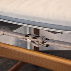 Close-up of a Kenya Armchair Cotton Canvas with a saddle leather belt with brass buckle and cotton canvas seat.