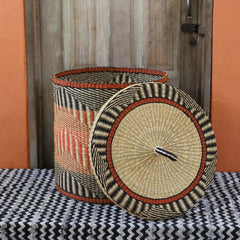 Baba Tree Handwoven Lidded Laundry Basket 00036 with black, orange and natural pattern made of elephant grass in Ghana
