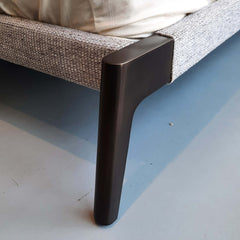 Upholstered king bed with metal legs and grey fabric, pictured without a footboard