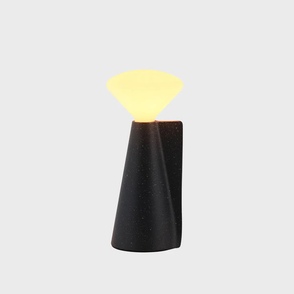 A portable lamp with a granite black base and LED bulb, by Tala