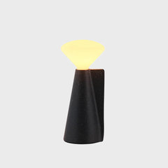 A portable lamp with a granite black base and LED bulb, by Tala