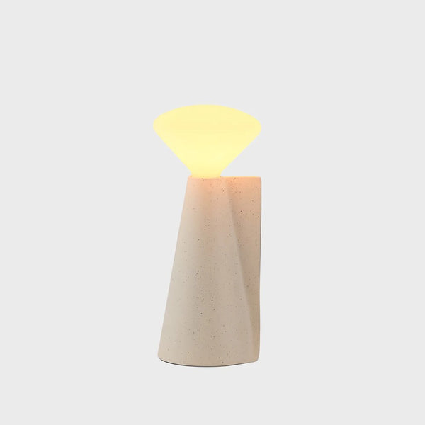 A portable lamp with a stone white finish, featuring a stainless steel structure and a Y-shaped LED light source.