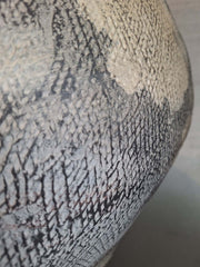 Close-up of a textured Metis Floor Vase with a patterned surface.