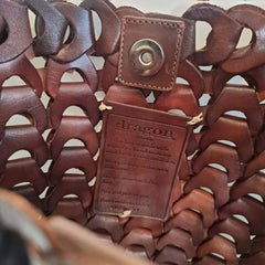 NS Link Tote Bruciato crossbody handbag with a textured, chain-like pattern made from recycled buffalo leather.