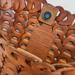 Close up of Dragon Diffusion NS Link Tote Tan crossbody handbag with a textured, chain-like pattern made from recycled buffalo leather.