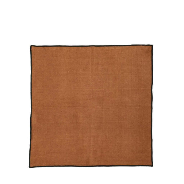 A square-shaped, ginger-colored linen napkin with a black cordon stitch edge, by ASA selection