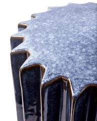 Close-up of a textured Okra Side Table with a wavy edge, by Pols Potten