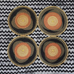 Baba Tree Handwoven Round Placemat 00023 with black, orange and natural pattern made of elephant grass in Ghana