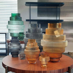 A collection of Steps Vases with vertical ridges, featuring an intricate and textured design, by Pols Potten