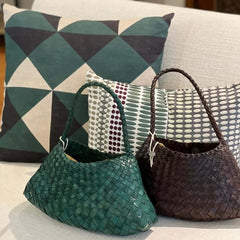 Dragon Diffusion Rosanna Forest and Dark Brown leather woven handbags on a couch