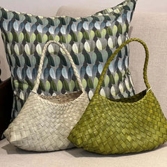 Dragon Diffusion Rosanna pearl and bamboo green leather woven handbags on a couch