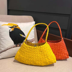 Dragon Diffusion Rosanna orange and yellow leather woven handbags on a couch
