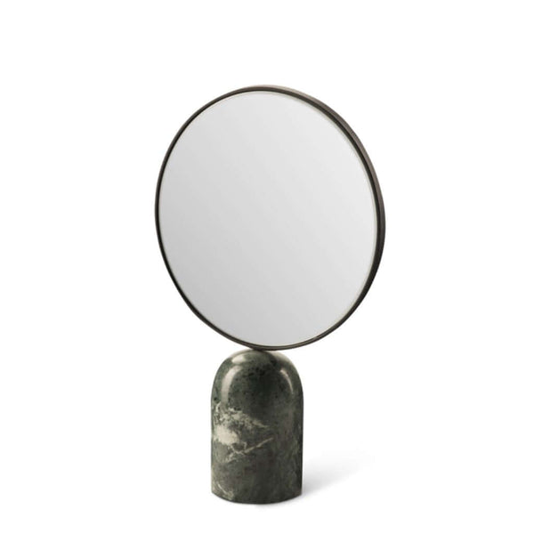 A round mirror with a dark green marble base and a plated iron frame, by Pols Potten