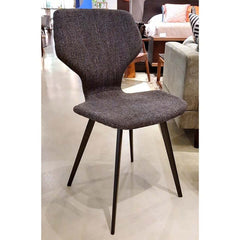 A contemporary style black upholstered dining chair with black metal legs.