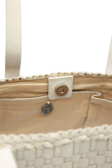 Close-up of a Dragon Diffusion Salvage Pearl woven leather bag with a pocket and a button