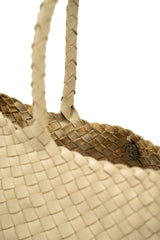 Dragon Diffusion Santa Croce Big Pearl with asymmetric leather straps and a woven basket-like design.