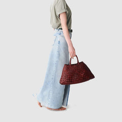 Dragon Diffusion Santa Croce Small Bordo with asymmetric leather straps and a woven basket-like design.