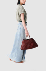 Dragon Diffusion Santa Croce Small Bordo with asymmetric leather straps and a woven basket-like design.