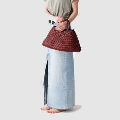 Dragon Diffusion Santa Croce Small Bordo with asymmetric leather straps and a woven basket-like design.
