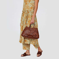 Dragon Diffusion Santa Croce Small Tan handbag with asymmetric leather straps and a woven basket-like design.