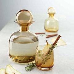 A mouth-blown, amber-colored Sarabi drinkware with a round, soft shape, by ASA selection