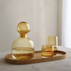 A family of amber-colored Sarabi drinkware with a smooth, round shape, by ASA selection