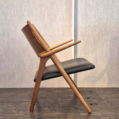 Sawbuck Lounge Chair Black Leather seat and backrest in teak natural finish